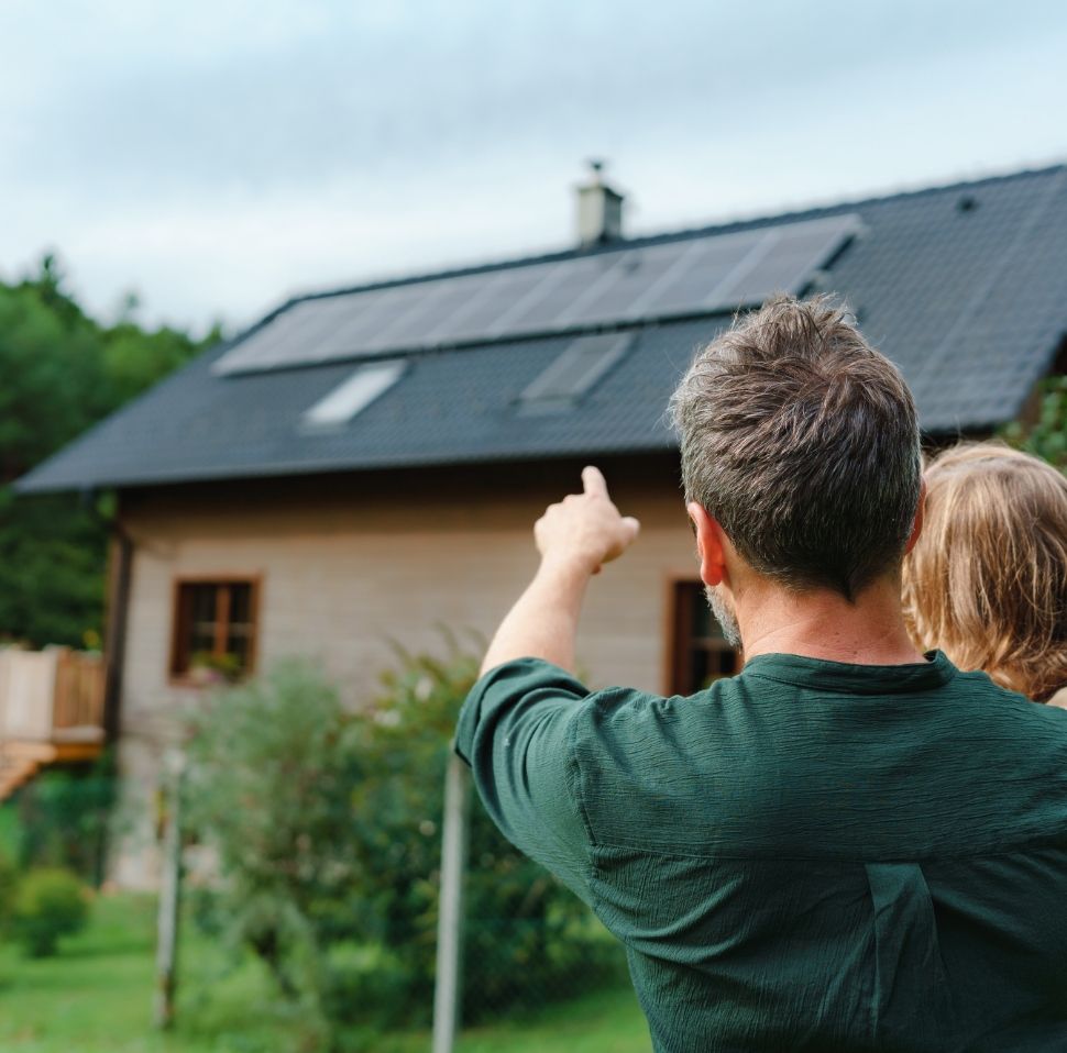 Family pointing at new solar panels